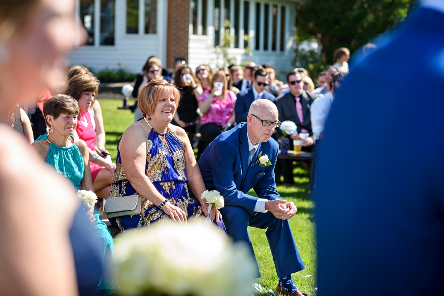 Parents of the bride watch their daughter get married.